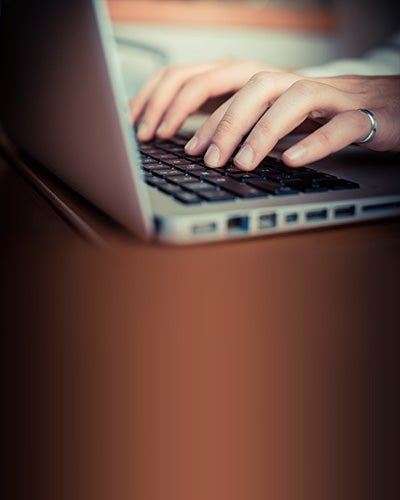 close up hands multitasking man using tablet, laptop and cellhpo