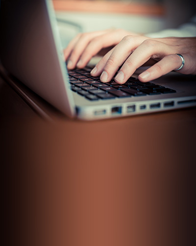 close up hands multitasking man using tablet, laptop and cellhpo